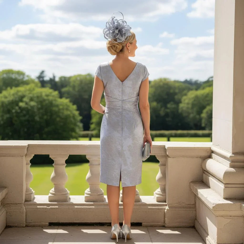 Woman in a light blue mother of the bride dress and jacket. Signature Dress