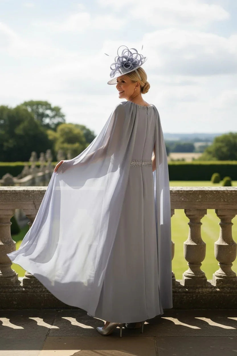 Rosa Clara Couture Club 8G151 blue"‘grey mother of the bride dress with flowing chiffon cape sleeves and embellished waistband, showing the back of the dress