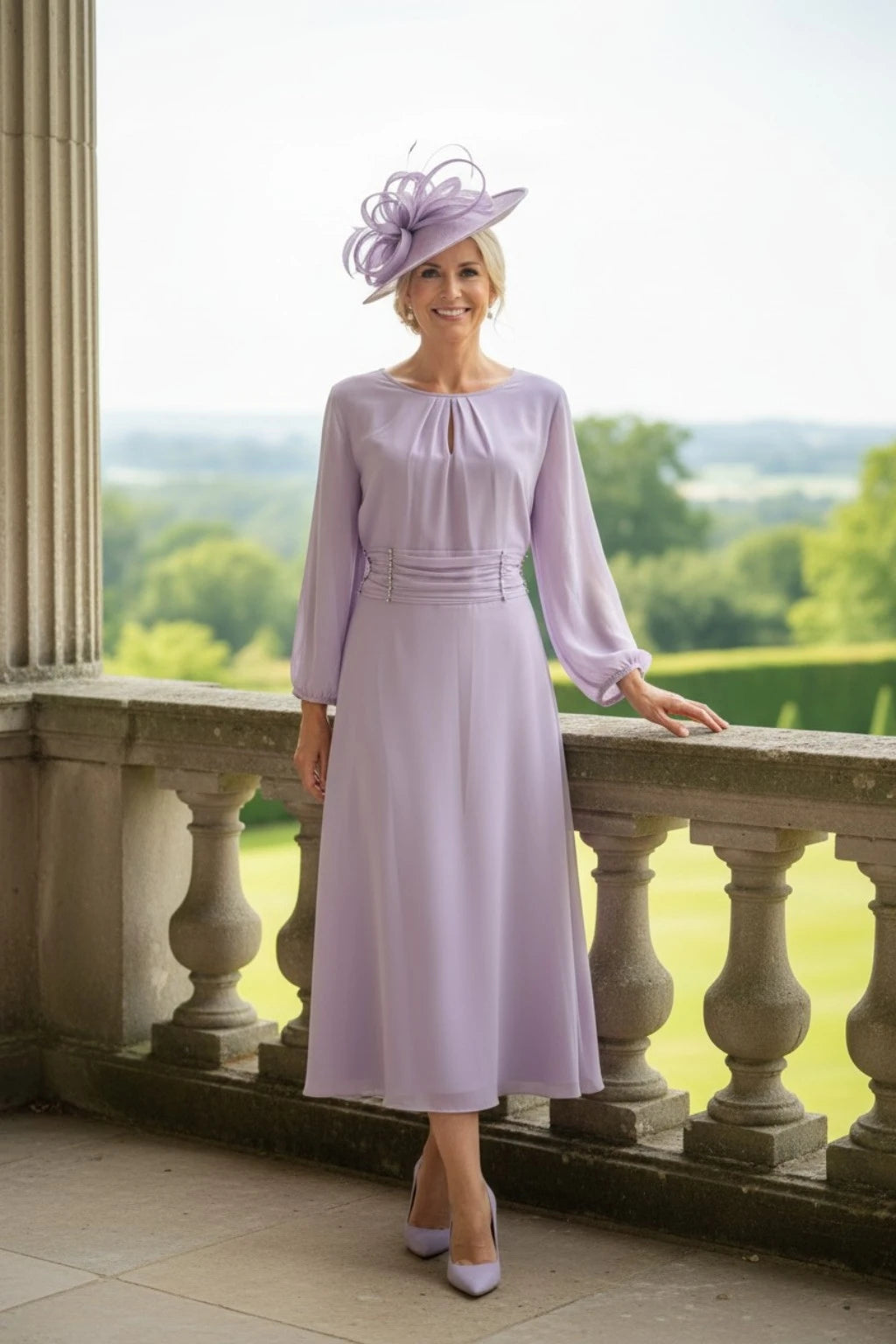 Woman in a light purple dress and hat standing on a balcony with a scenic view.