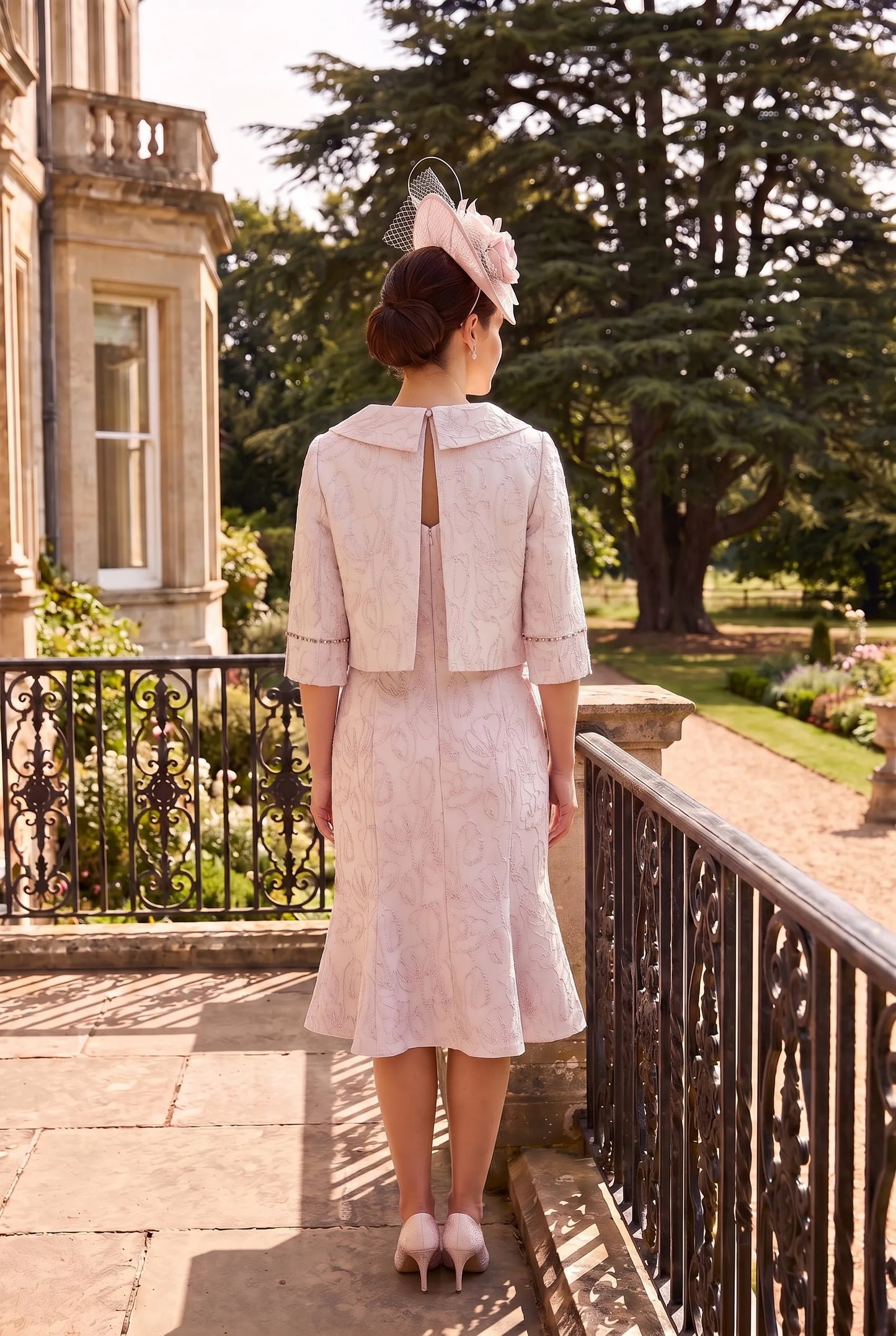 Rear view of the Pink Mother of the Bride Outfit by Lizabella 7153 showing the back-fastening cropped jacket and elegant fitted silhouette.