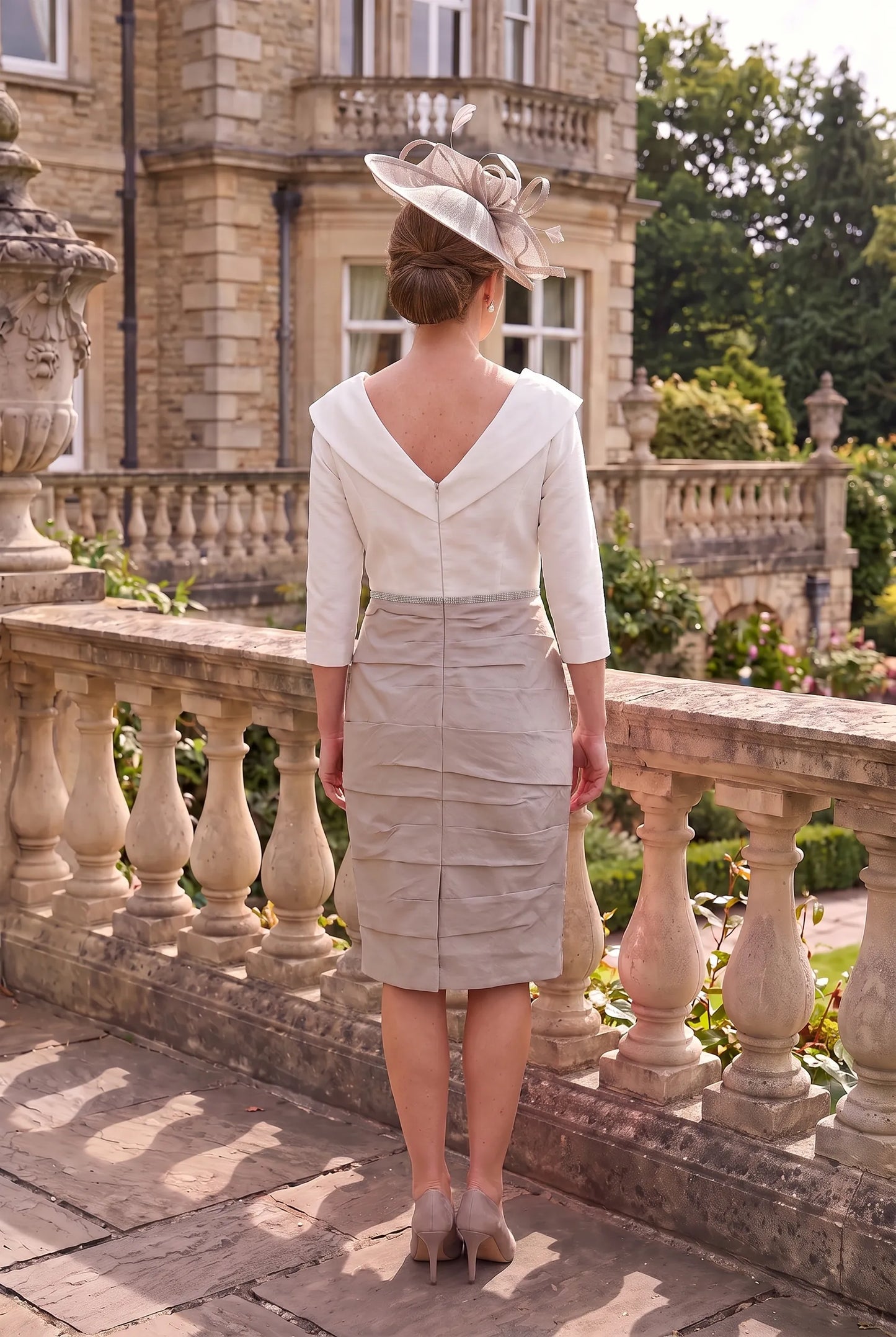 Rear view of the Taupe Mother of the Bride Dress by Ispirato ISK817 showing the elegant fitted silhouette and back detailing.