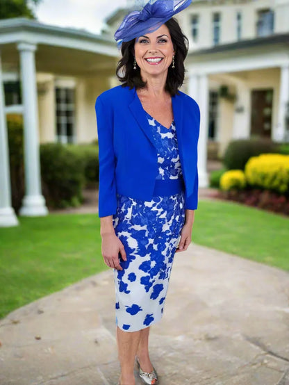 Woman wearing a blue floral dress with a matching jacket and hat on a white background