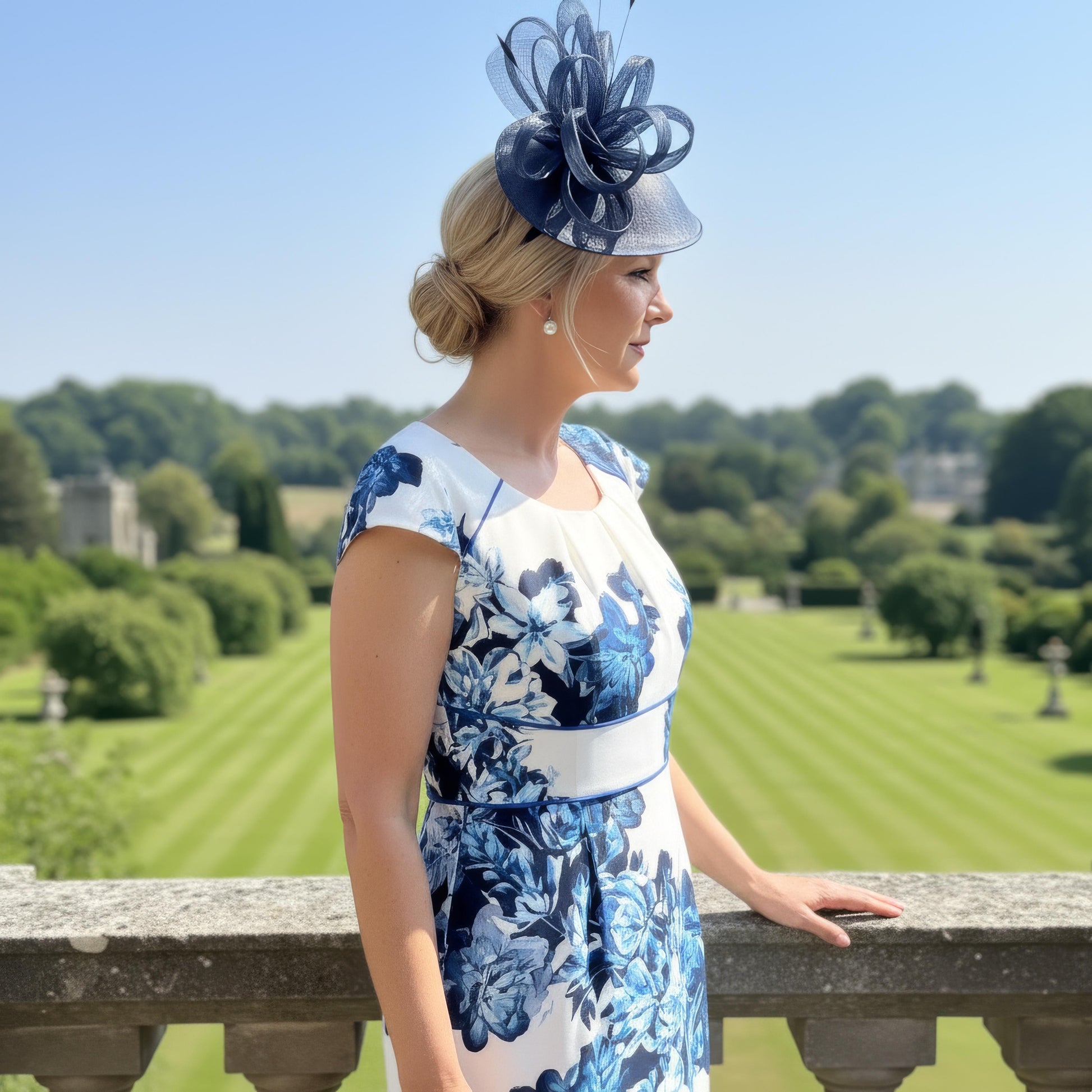 Condici 70820 navy dress and jacket set shown outdoors, highlighting the soft ruching on the dress and the tailored three‑quarter sleeve jacket with contrast trim.