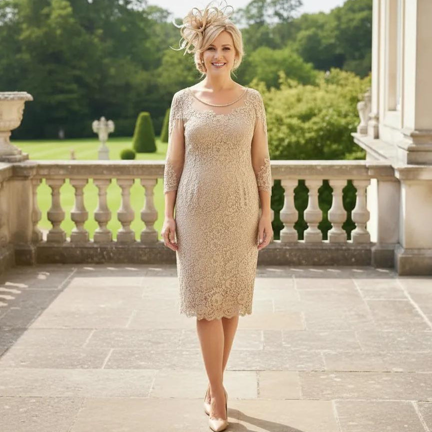 Woman in a condici beige mother of the dress and matching beige fascinator ready to attend a wedding. Signature Dress.