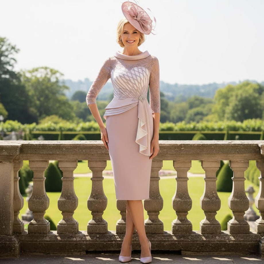 Woman in a Rosa Clara Couture Club light pink mother of the bride dress and pink fascinator hat standing on a stone balcony with a scenic background. Signature Dress.