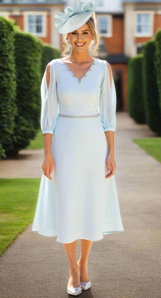 Woman wearing a light blue dress with a matching hat on a white background