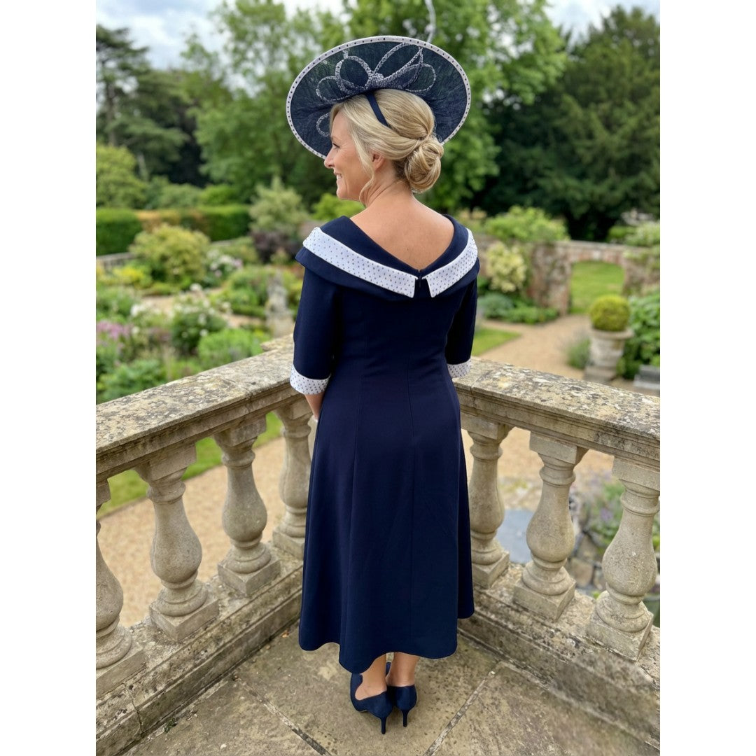 Back view of the Lizabella 2461 navy dress showing embellished neckline and longer back hem.