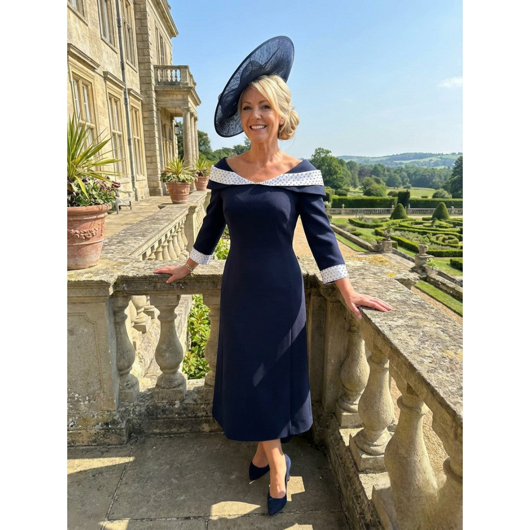 Navy mother of the bride dress by Lizabella, style 2461, with pearl and rhinestone neckline and high‑low hem.