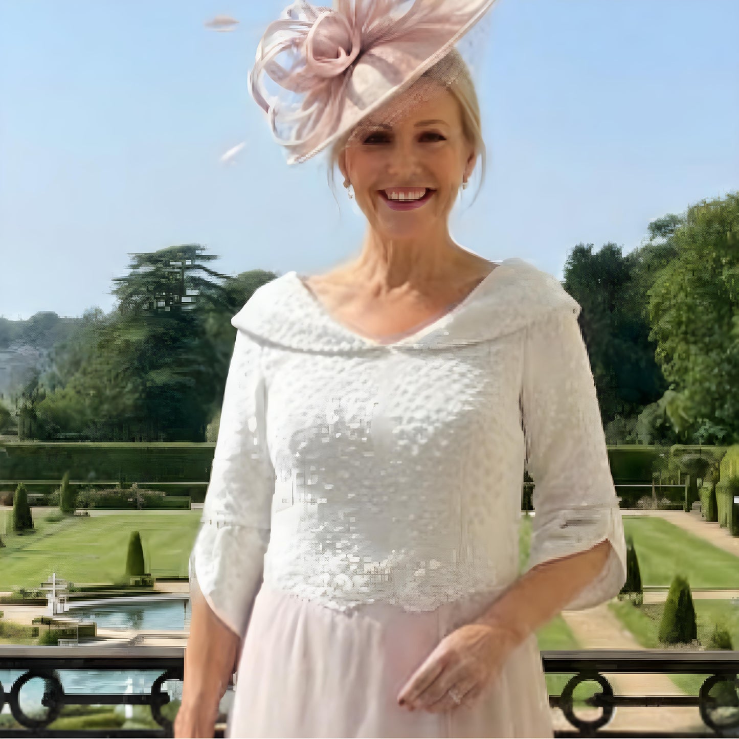 Woman in a blush pink Mother of the bride dress by Lizabella. Signature Dress