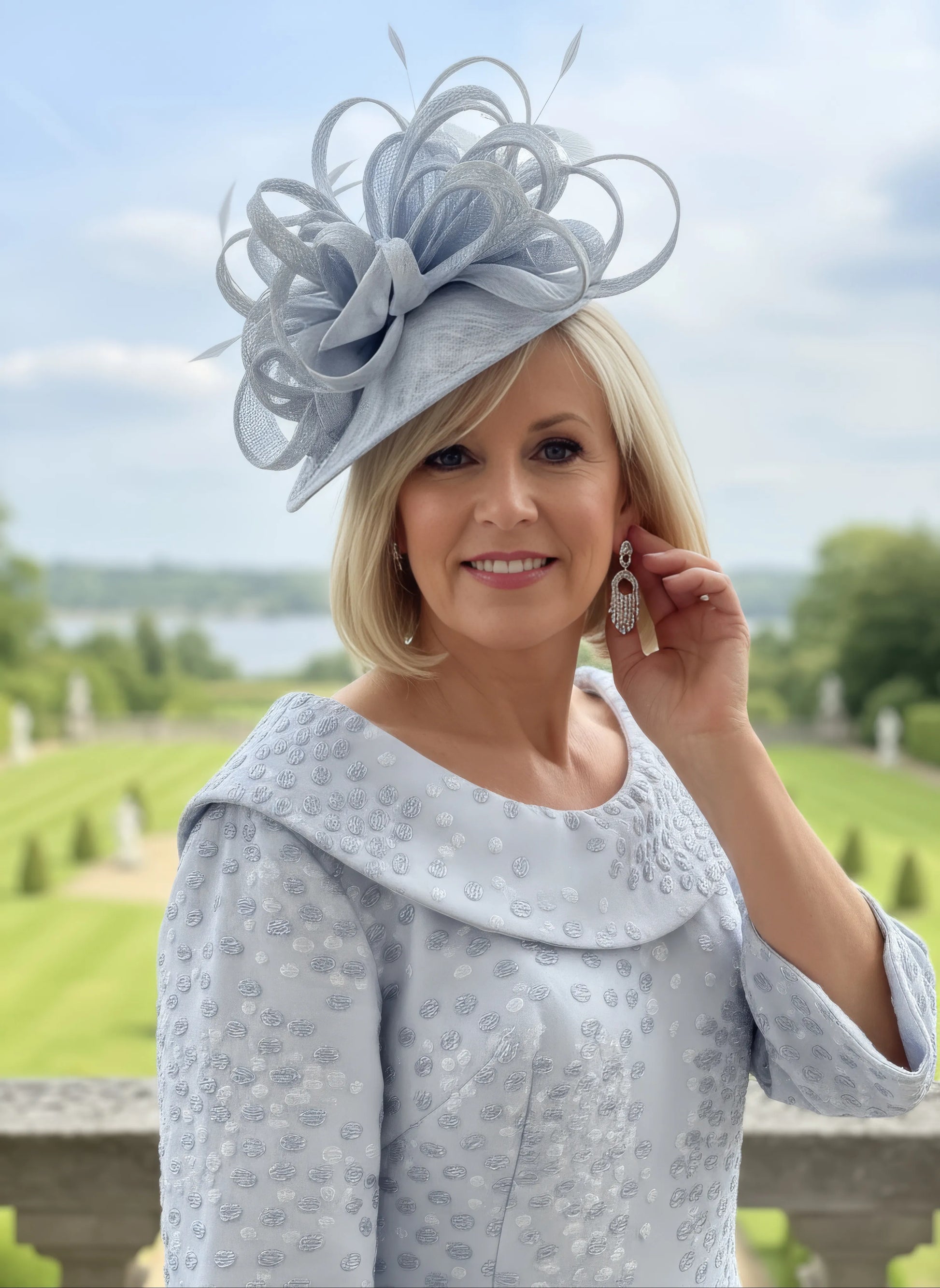 Woman wearing a light blue dress and matching hat with a scenic - Lizabella 2378 Mother of the Bride Dress Blue 