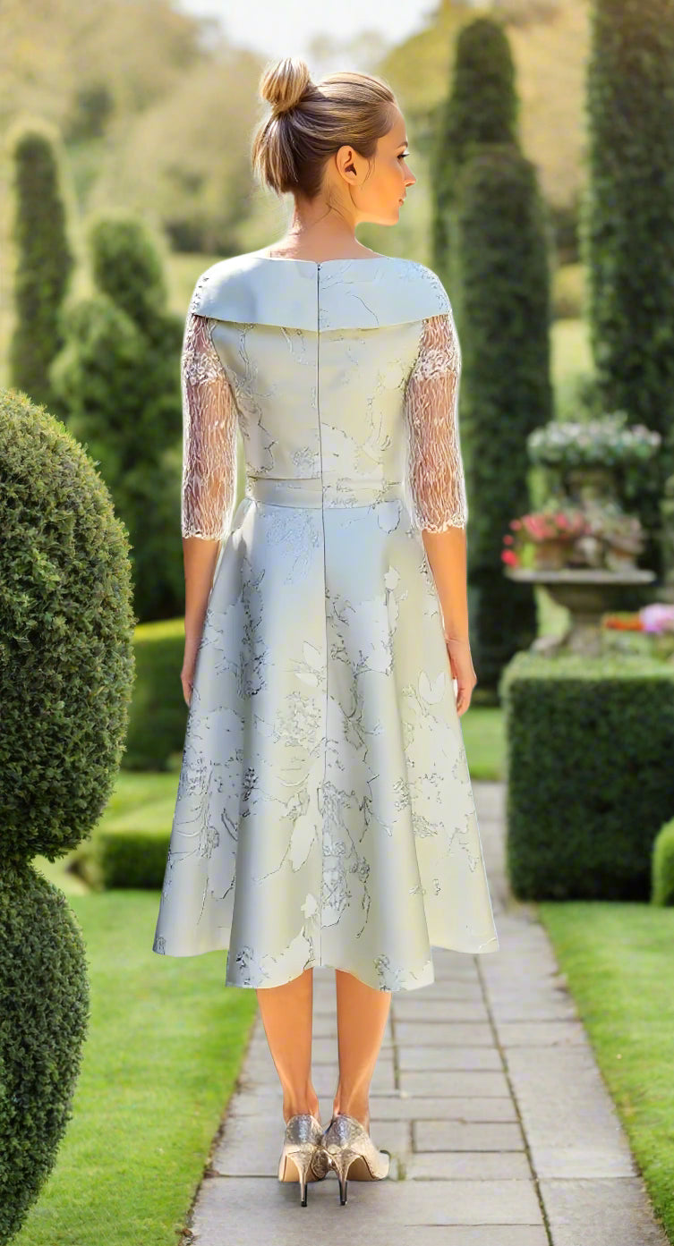 Woman wearing a light green lace dress as mother of the bride