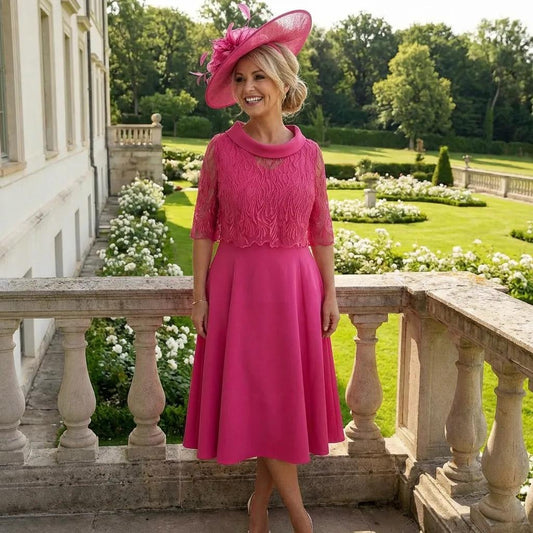Woman in a Lizabella a-line pink mother of the bride dress and matching pink fascinator hat ready for wedding. Signature Dress.
