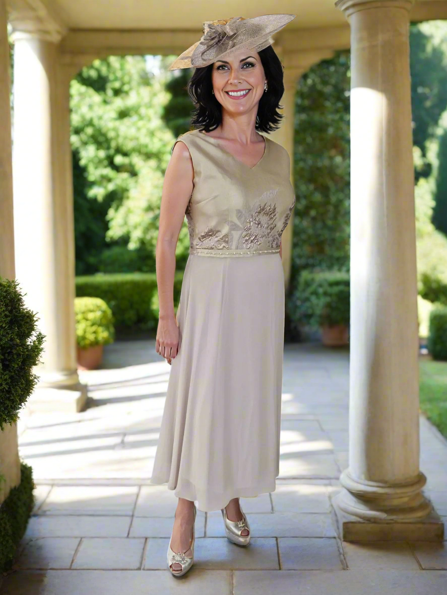This has a floaty skirt. The bodice is the same material as the front cover drape jacket. There is a bead and diamanté embellishment at the waist on the front of the dress, the jacket has a lightweight chiffon scoop neck and chiffon sleeves.