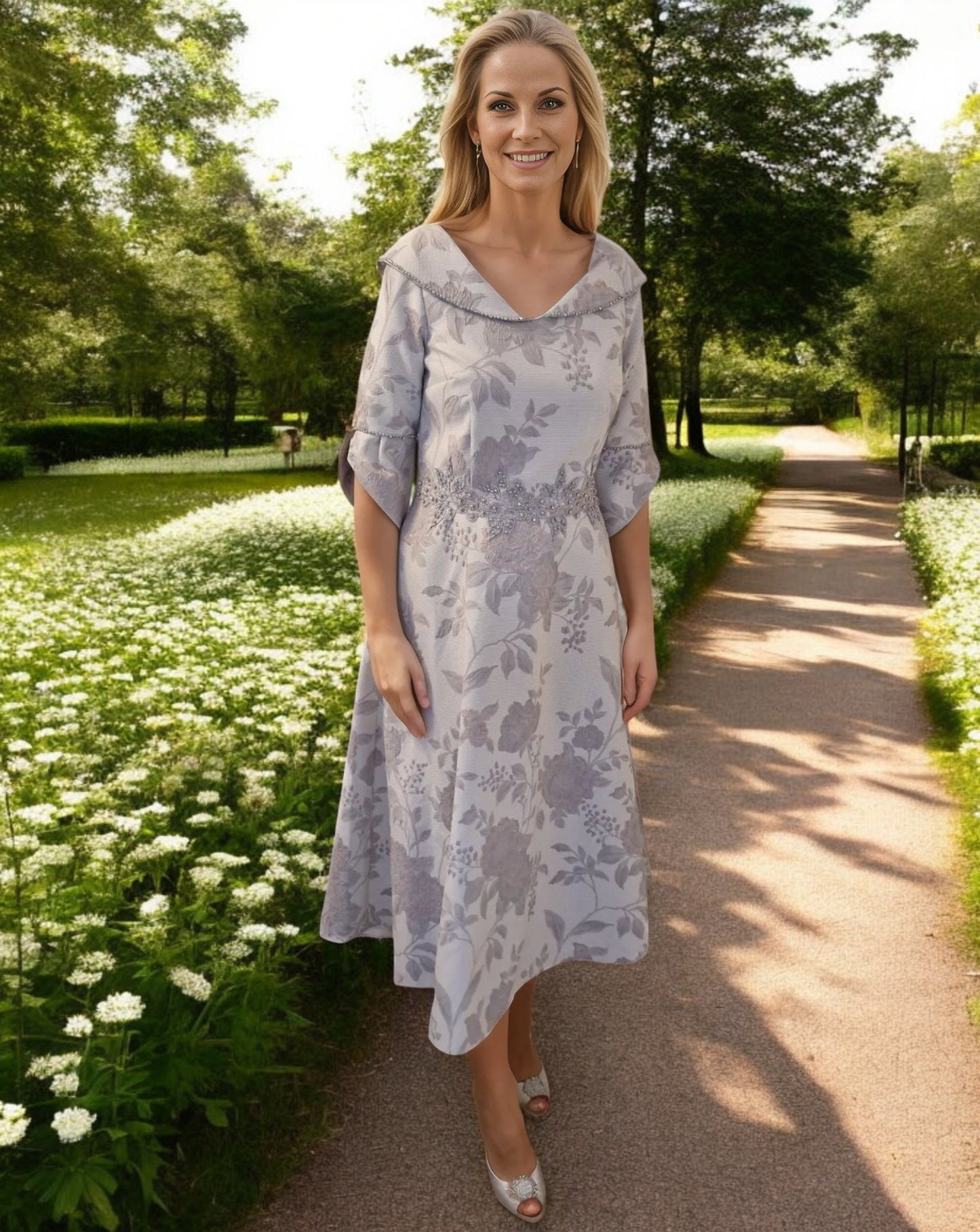 A jacquard and floral print A line Dress with a beautiful V neck line collar detail.

Bell cuff sleeves that finish at the elbow with sparkling detailing on the cuffs and to the collar and slip side pockets.