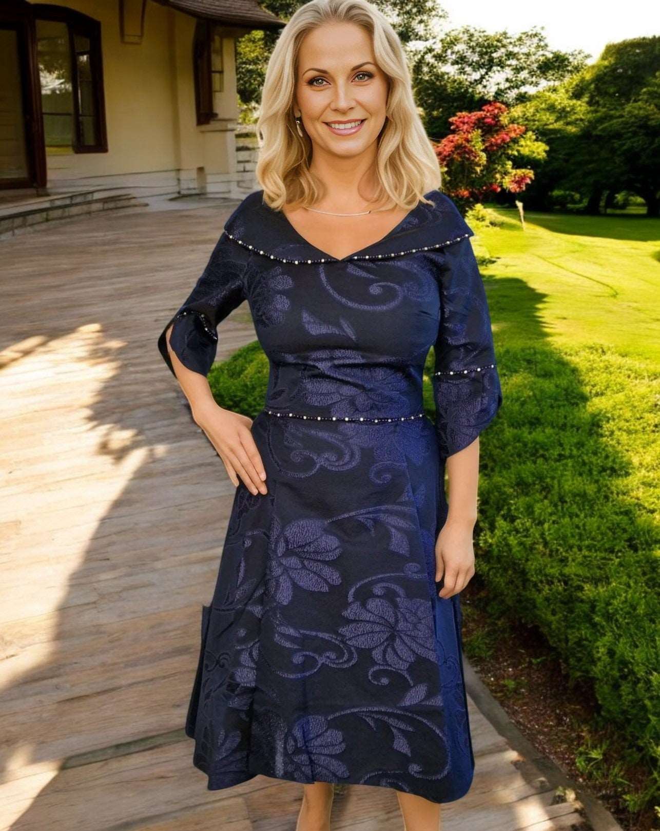 Stunning Navy dress by designer Lizabella , fit and flare style with high low skirt and slip side pockets, has a V shaped with fluted sleeves and finished with sparkly beads and pearls to the waist, neckline and cuffs.