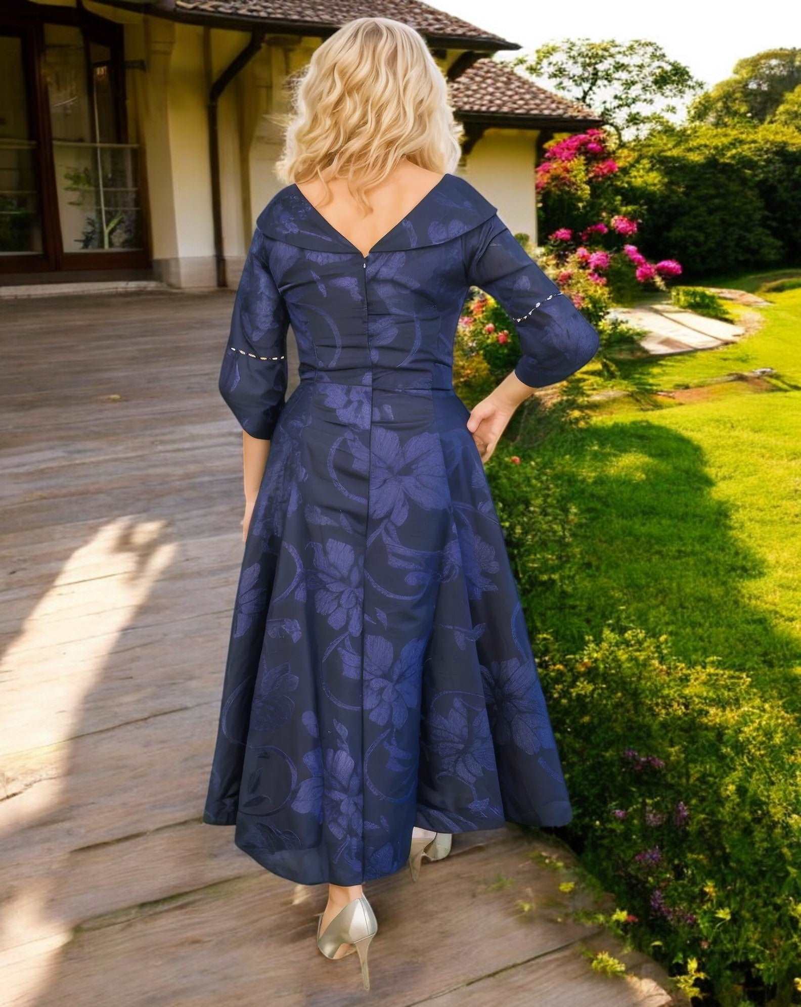 Stunning Navy dress by designer Lizabella , fit and flare style with high low skirt and slip side pockets, has a V shaped with fluted sleeves and finished with sparkly beads and pearls to the waist, neckline and cuffs.