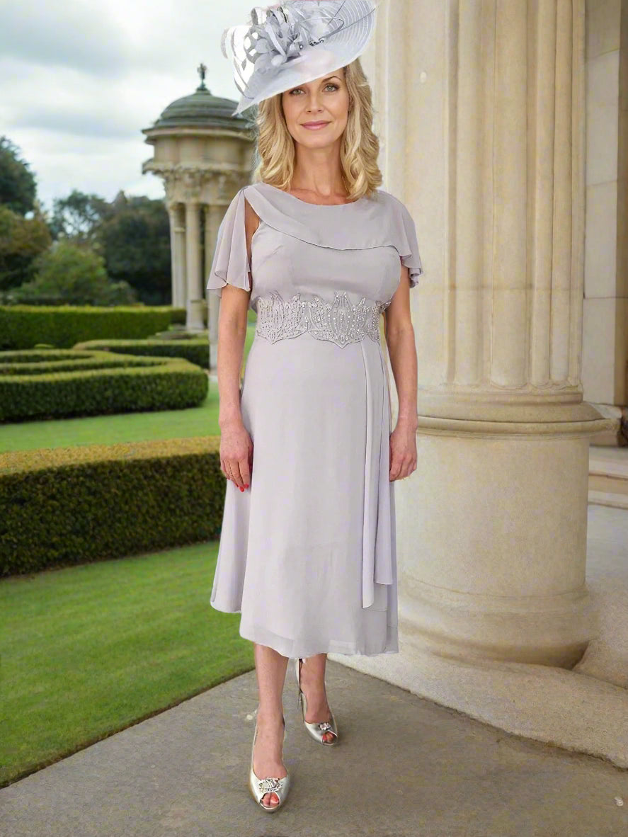 Mother Of The Bride beautiful chiffon dress by Lizabella, is a fit with slight flare and a attached cape looking sleeve, concealed zip to the back and lined, finished with embellished beads to the centre front.