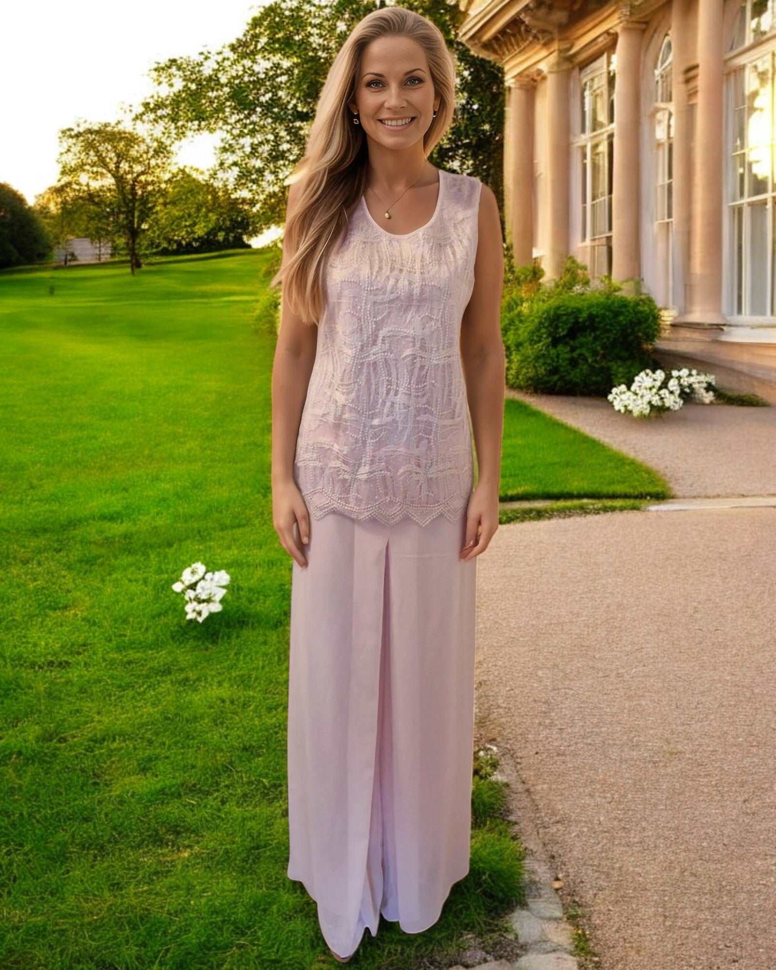 Mother of the bride 3 piece trouser suit from Lizabella is in blush pink colour, chiffon wide leg trousers, sleeveless lace round neck top with chiffon lightweight jacket