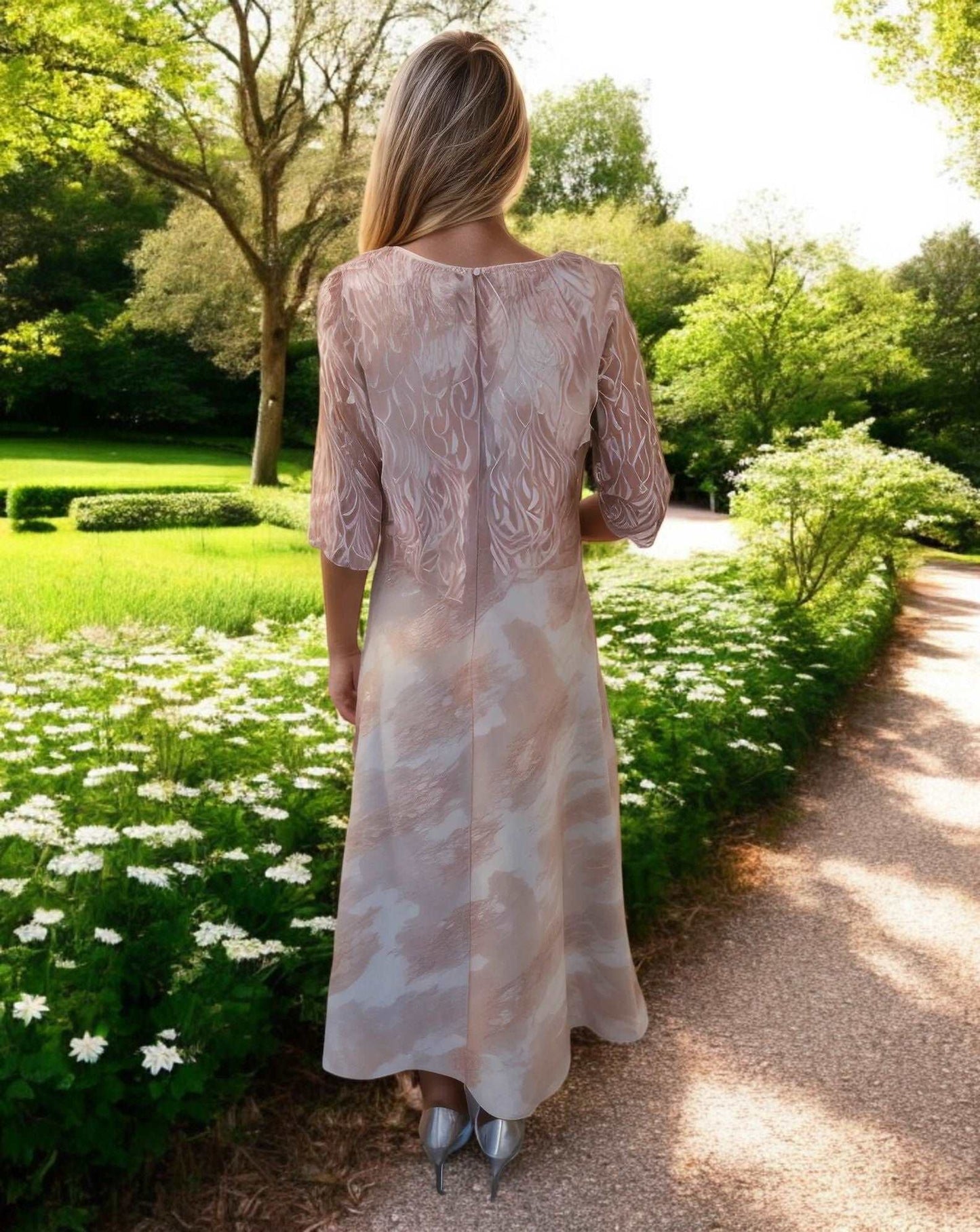 This beautiful 2 piece outfit for the Mother of the Bride features a stunning pink fit and flare dress paired with a lace over jacket. The waist is adorned with beautiful beads and pearls, and the skirt even has convenient slip pockets.