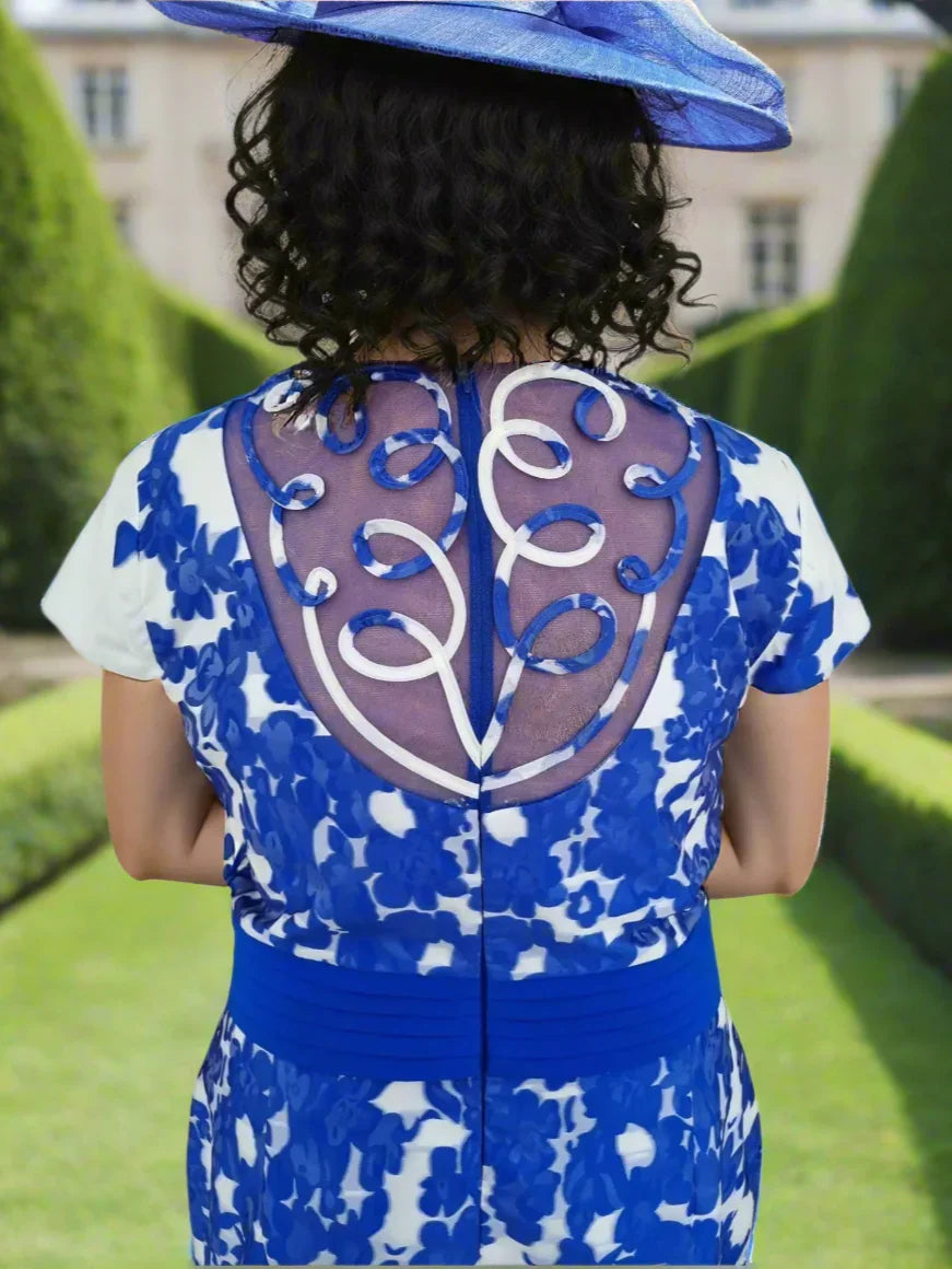 Blue and white patterned dress with a decorative back design on a white background