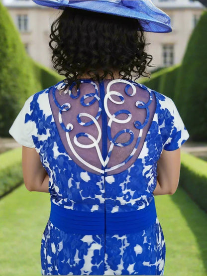 Blue and white patterned dress with a decorative back design on a white background