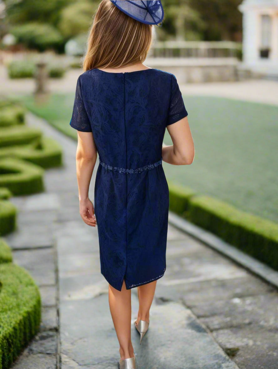 A navy lace dress featuring bead embellishments to the waist, short sleeves, a stretch fabric, a zip closure at the back, a chiffon jacket, and a padded bust, cut to knee length.