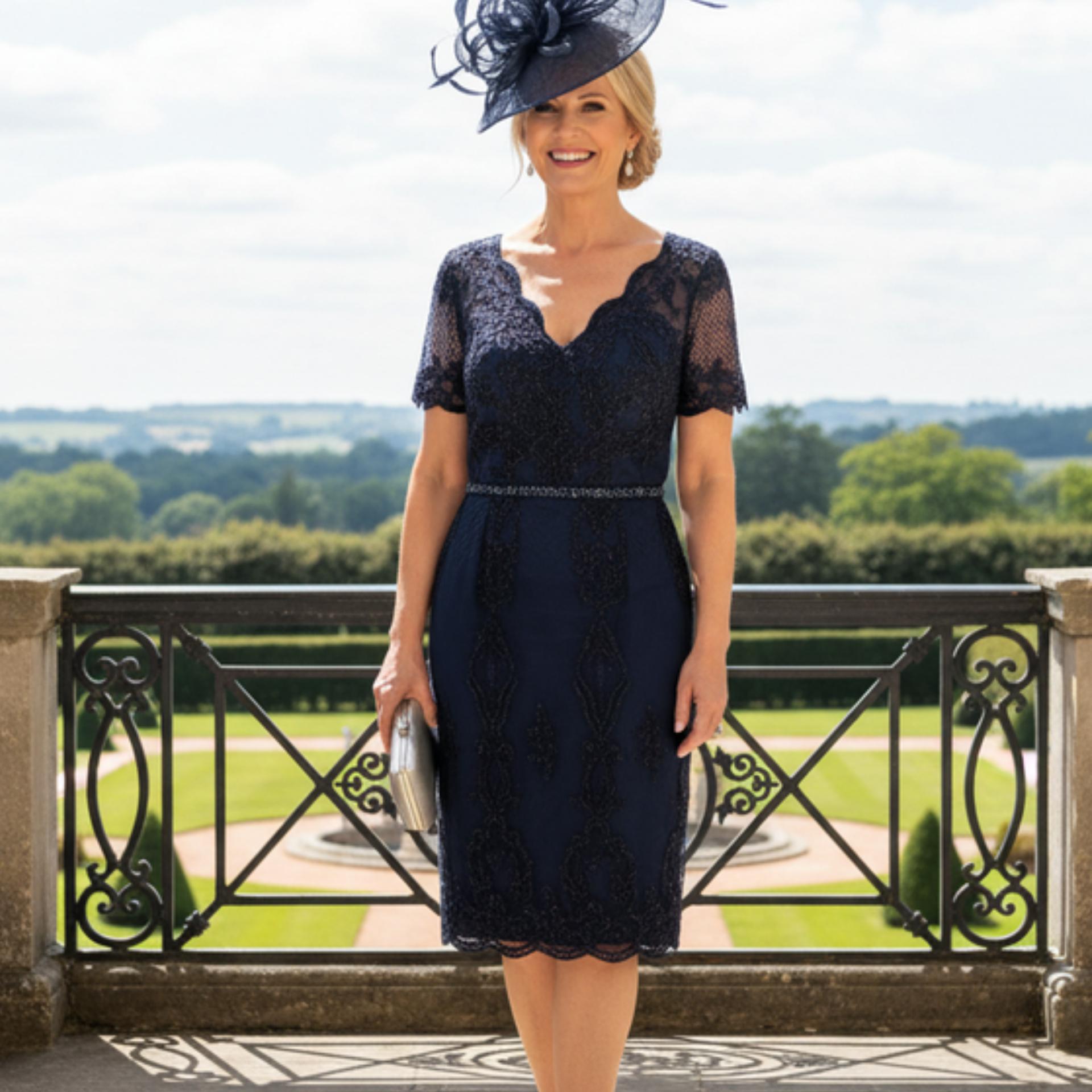 Woman in a navy lace mother of the bride dress. Signature Dress