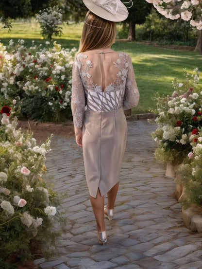 Layering ivory and taupe, the sheer lace sleeves add just enough coverage, while the ruched waistline is effortlessly flattering to every shape, complete with a delicately embellished finishing touch.