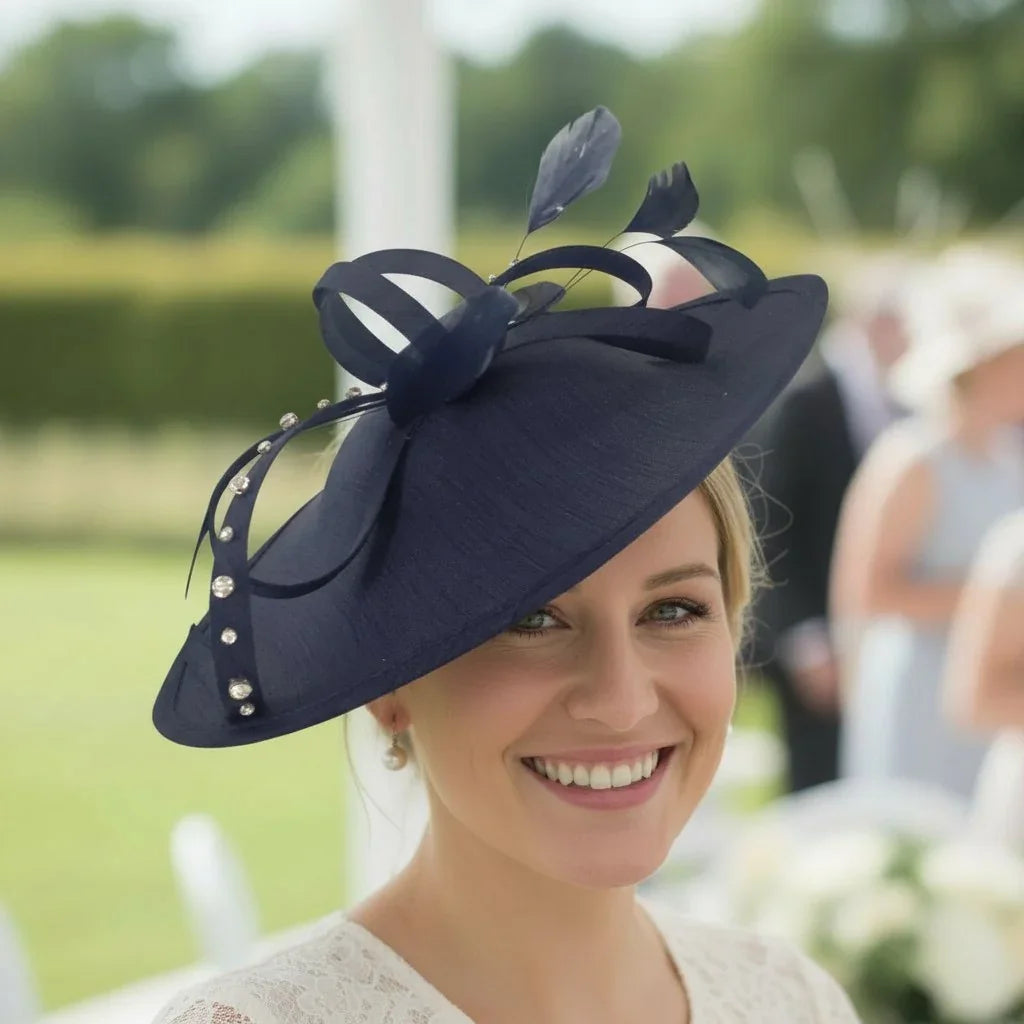 Woman wearing a navy blue hat with decorative elements, smiling outdoors.