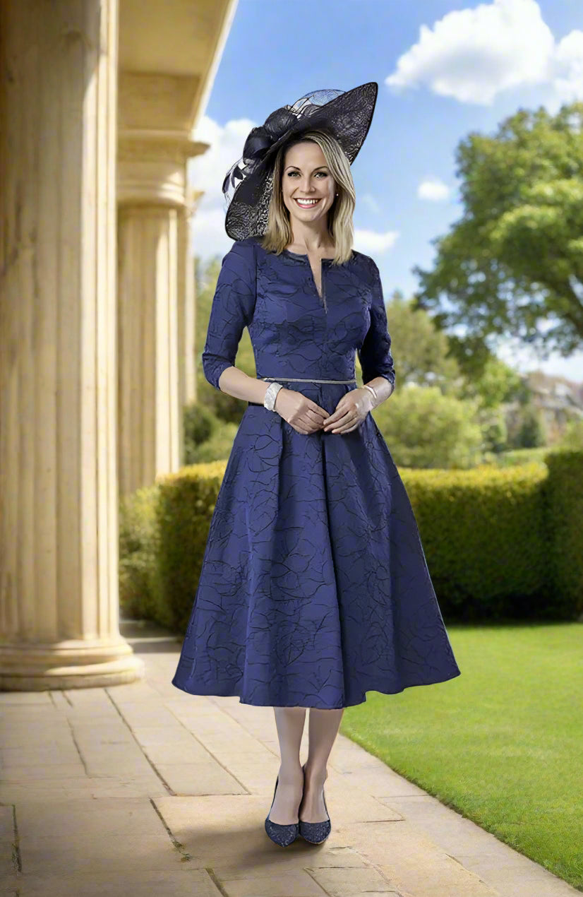 A perfect choice for a casual wedding, the races or any special event, this full-skirt Navy brocade dress features a delicate waistline detailing for a flattering touch.