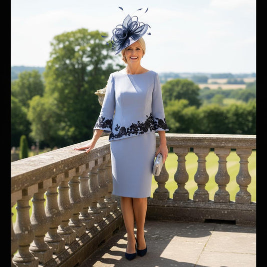 Woman in a light blue mother of the bride dress with navy floral lace by veni infantino - Signature Dress.