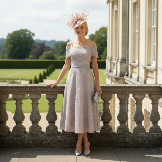 Stunning dress by Veni Infantino which would grace any wedding

Steel coloured lace with a blossom underlay

Jewelled straps with a lace drape which creates a sleeve

Semi full skirt with bead detail to waist