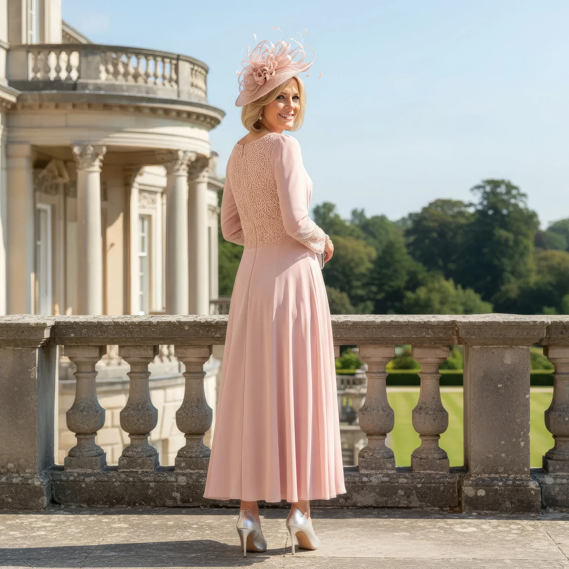Woman in a pink veni infantino dress with a matching fascinator 