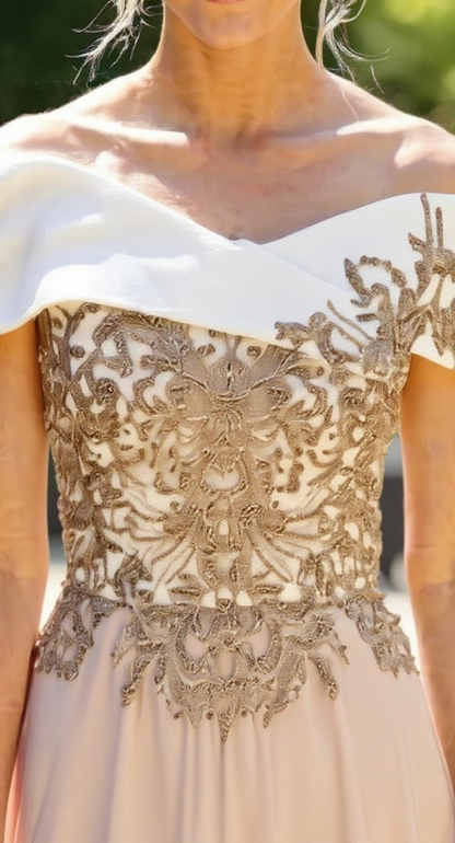 Close-up of a white dress with gold lace detailing