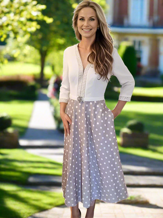 Concealed zip at back, fully lined. Pearls and beads adorn tea-style dress in taupe &amp; ivory. Side slip pockets.