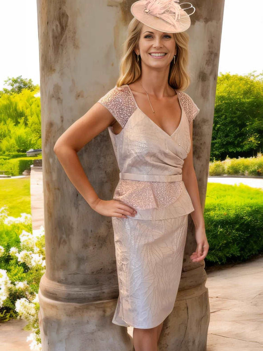 Ronald Joyce designer Veni Infantino Elegant dress with a peplum waist and fish tail back.

The Dress has a concealed zip to the back, padded bust, in a rose gold Colour it is lined and finished with a fishtail