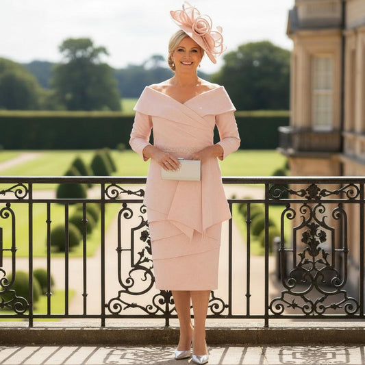 Woman in a veromia pink mother of the bride dress standing on a balcony at a wedding.Signature Dress.