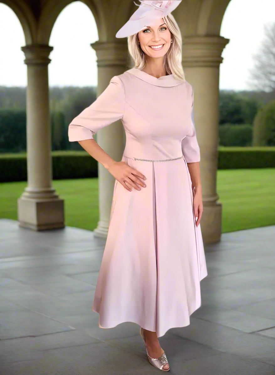 Veromia Mother of the Bride dress is elegantly crafted with a beautiful pink hue, midi length, 3/4 sleeves, and a full net skirt for a 50's aline silhouette.