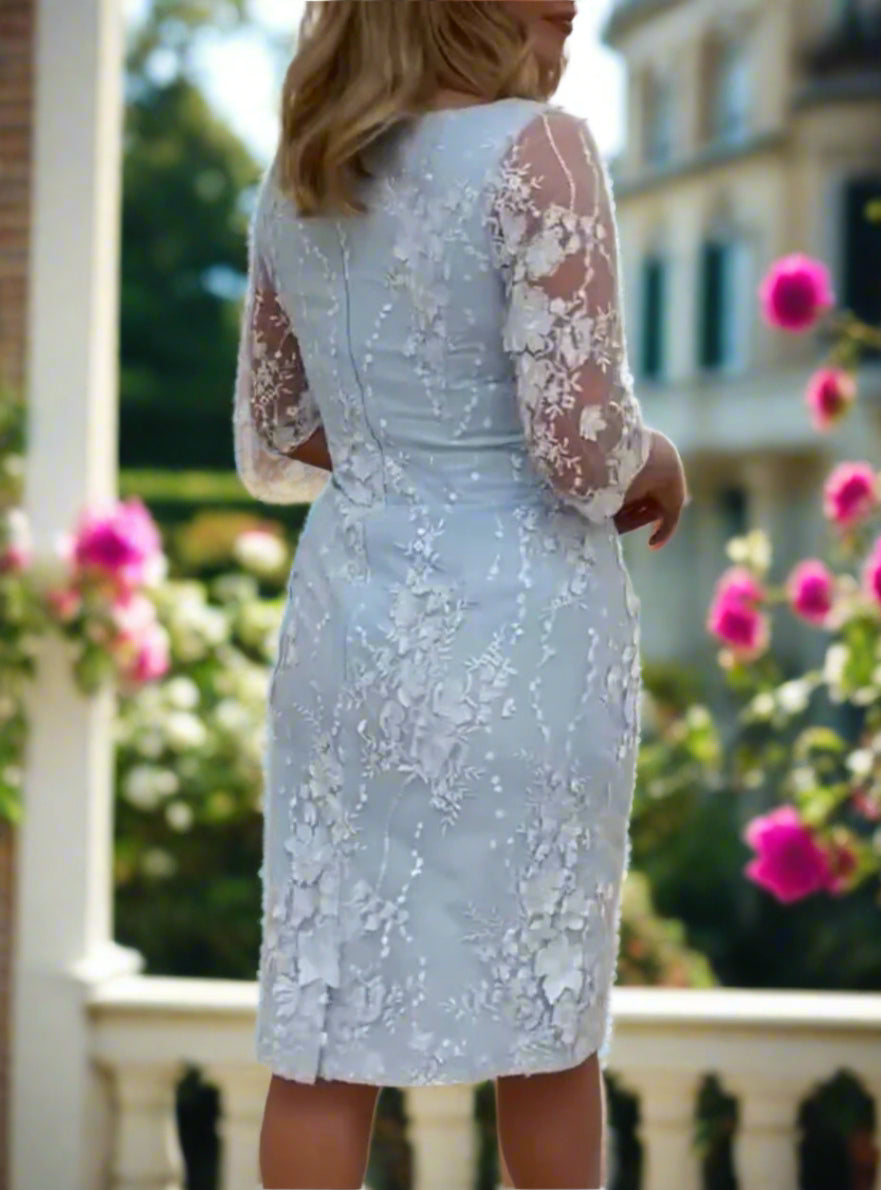 Mother of the Bride dress with floral lace overlay, embellished sleeves, v-neckline, and lined interior. Perfect with heels and fascinator for a stunning look.