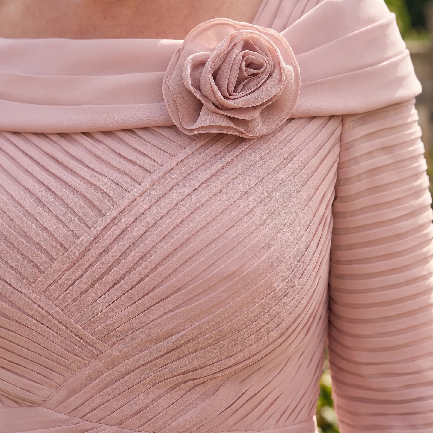 Close-up of the Couture Club 5G114 Blush Pink Mother of the Bride dress highlighting the floral neckline, ruched bodice and pleated detailing.