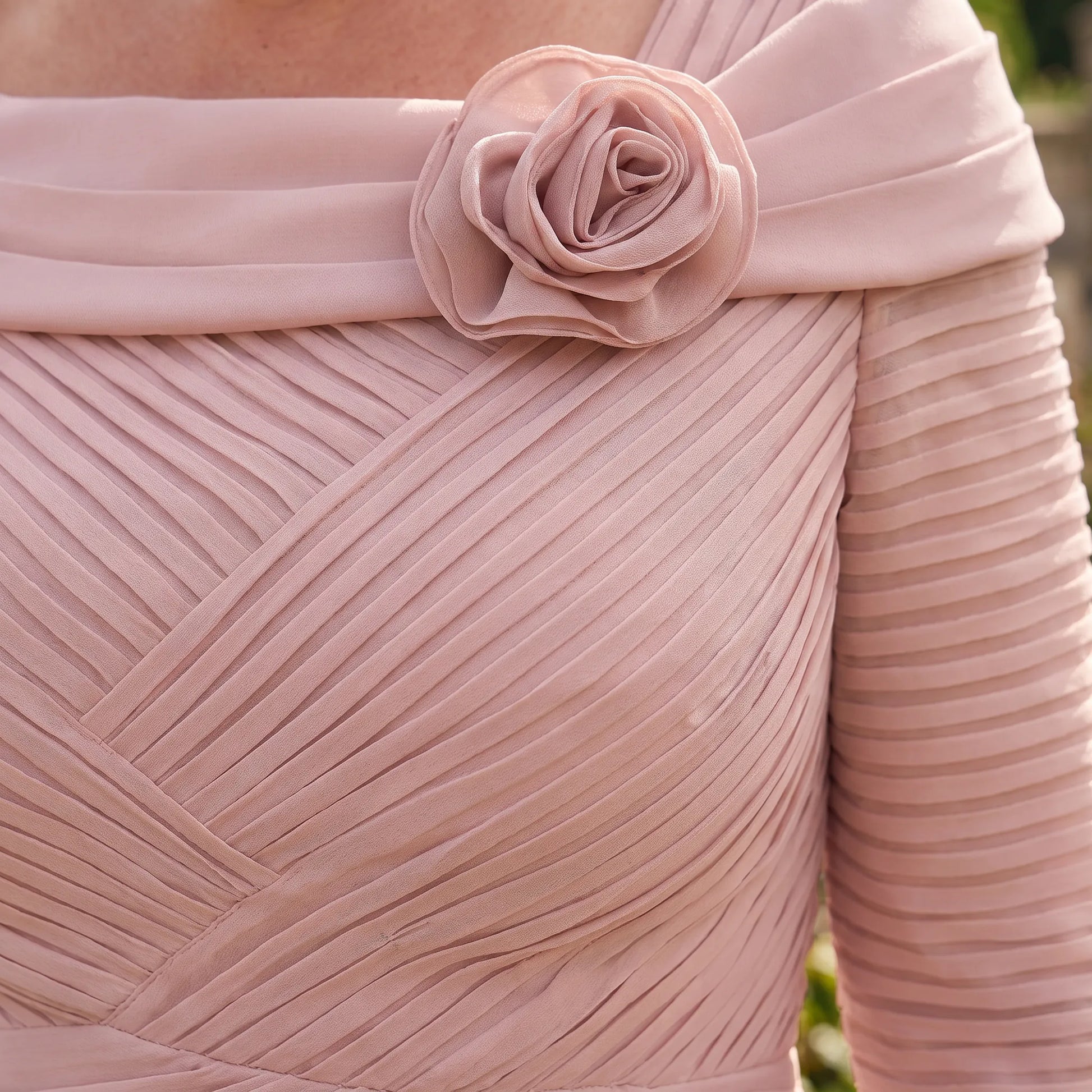 Close-up of the Couture Club 5G114 Blush Pink Mother of the Bride dress highlighting the floral neckline, ruched bodice and pleated detailing.