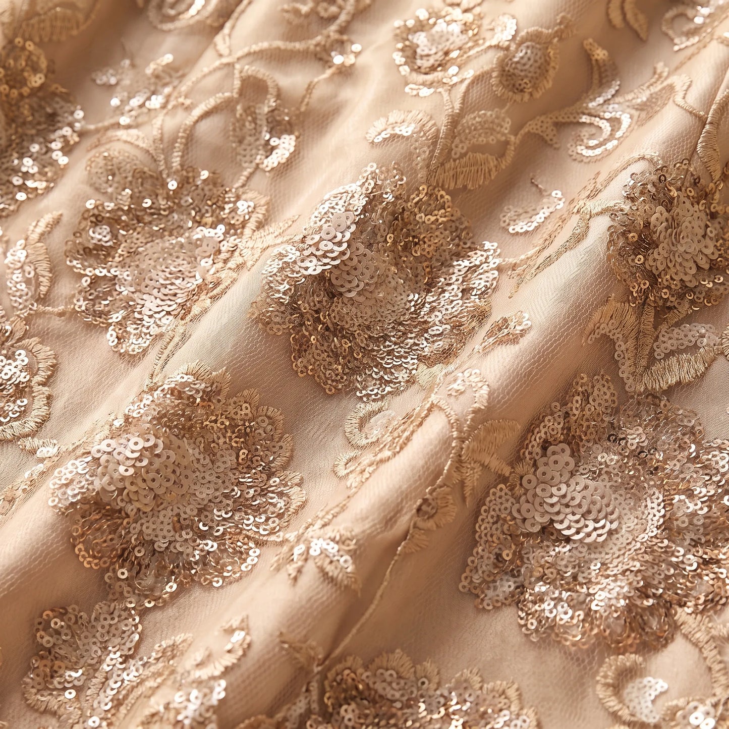 Close-up of the Lexus 1251 champagne gold embroidered fabric featuring intricate sequin floral detailing.