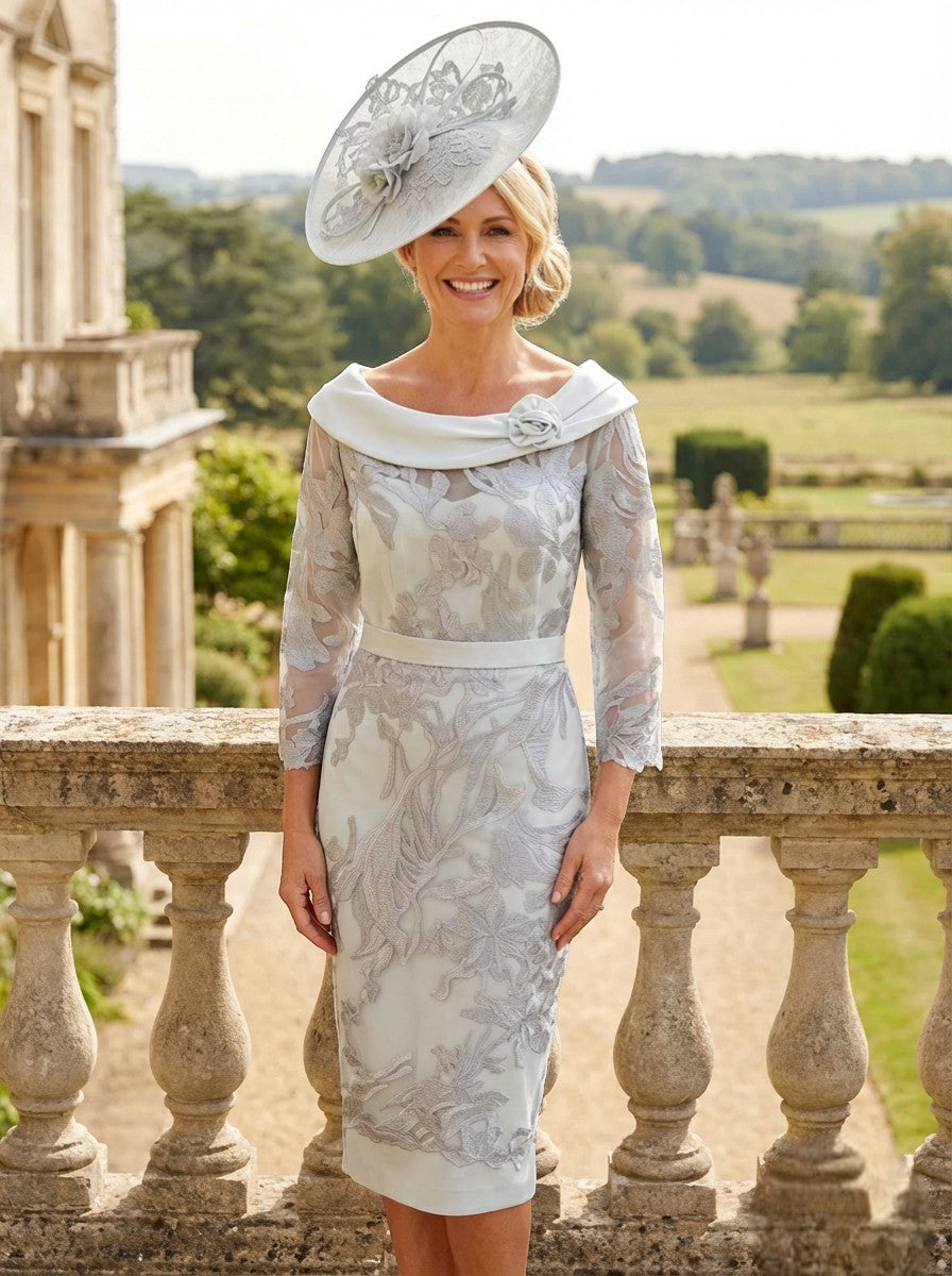 Mint green Couture Club 4G171 mother of the bride dress with silver lace and wide neckline, worn outdoors on a terrace.