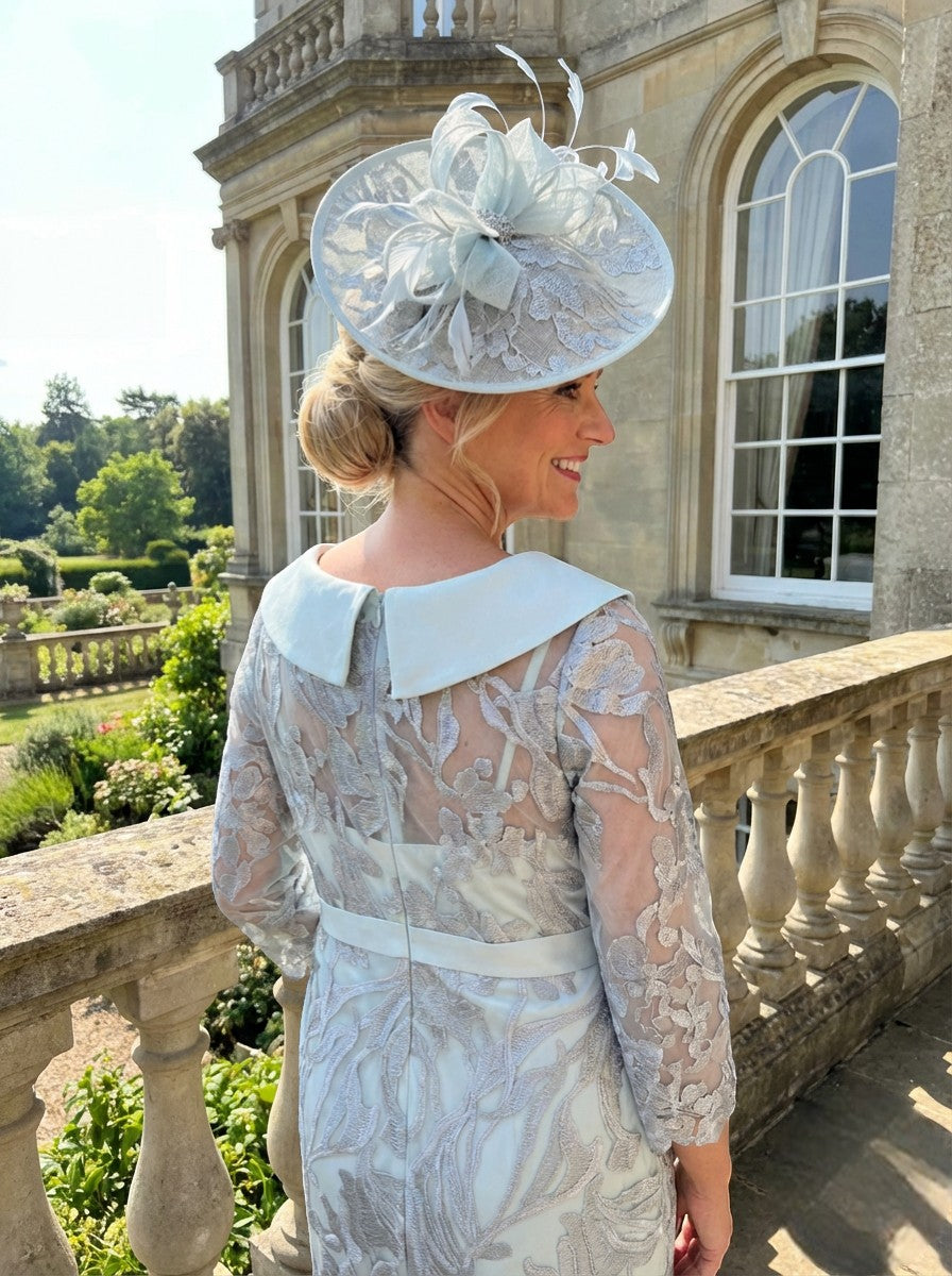 Close-up of mint green Couture Club 4G171 dress with silver lace embroidery, sheer sleeves and floral neckline detail.