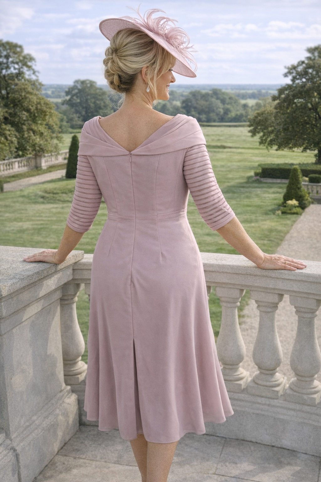 Back view of the Couture Club 5G114 blush pink mother of the bride dress with V-back detail and flowing chiffon skirt.