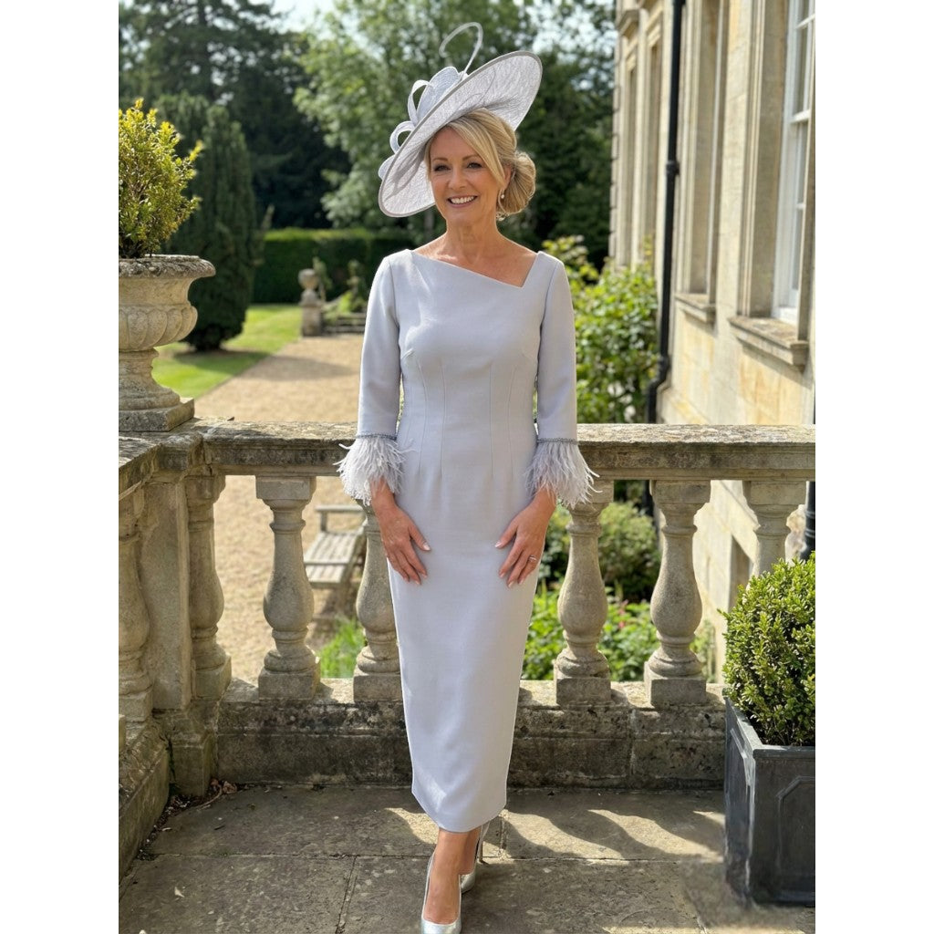 Fely Campo 23053 silver mother of the bride dress with feather cuffs, photographed outdoors at a stately venue.