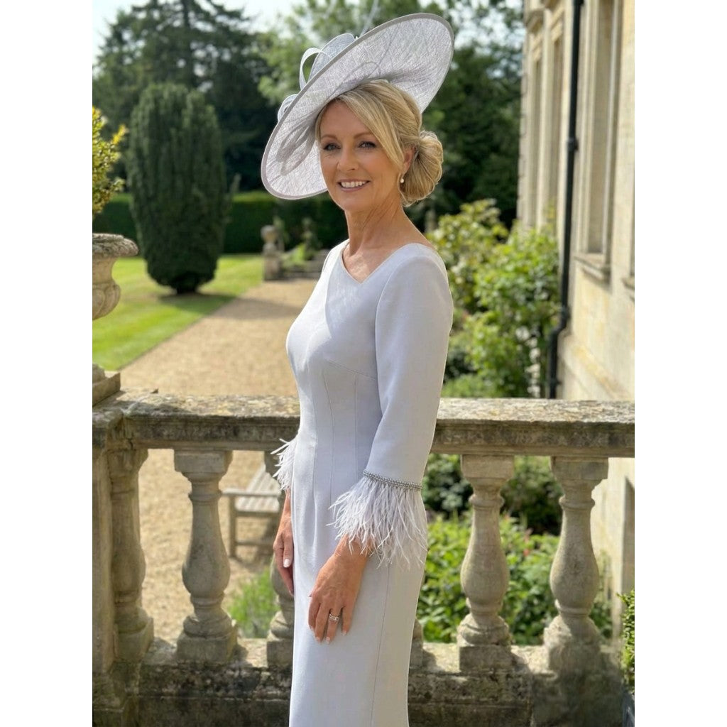 Side view of the Fely Campo 23053 silver mother of the bride dress with dramatic feather cuffs