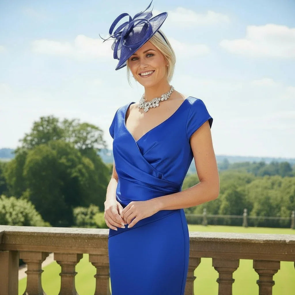 Woman in a cobalt blue ispirato mother of the bride dress and bespoke fascinator as Mother of the Bride - Signature Dress