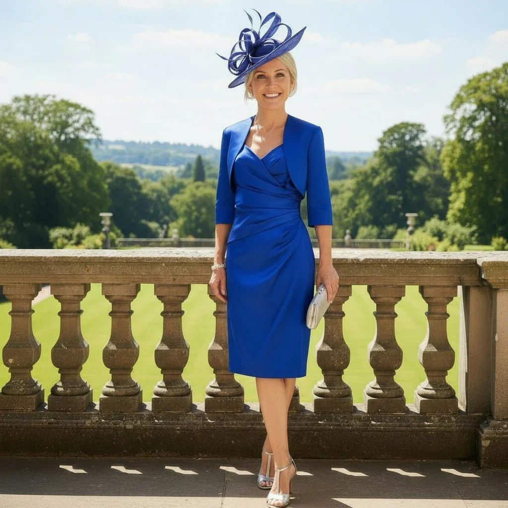 Woman in a cobalt blue ispirato mother of the bride dress, Jacket and bespoke fascinator as Mother of the Bride - Signature Dress