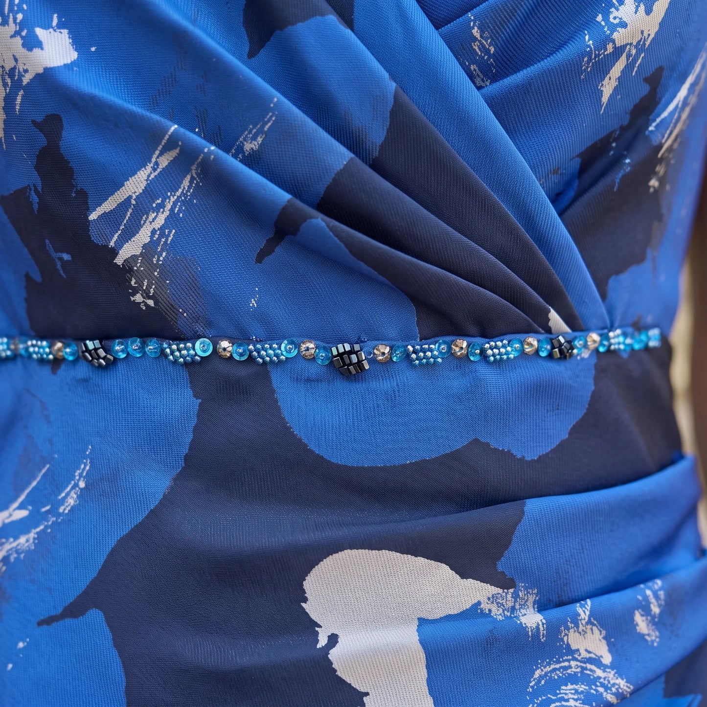 Close-up of the embellished waistband on the Ispirato ISJ802 royal blue mother of the bride dress.